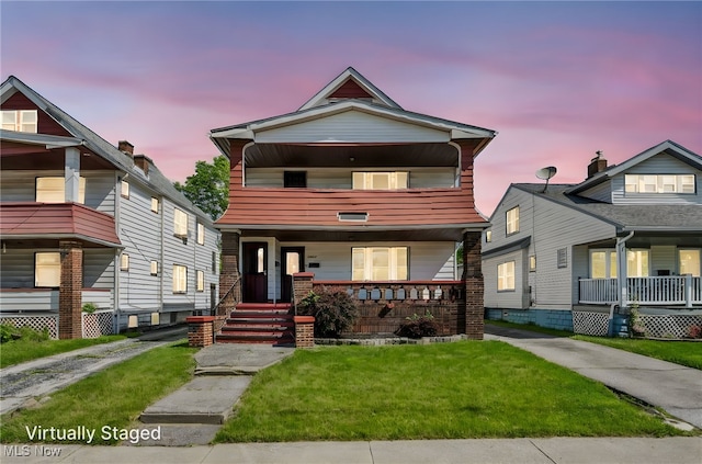 12117 Craven Ave, Cleveland, OH 44105 - view of front of house featuring a porch, a balcony, and a yard