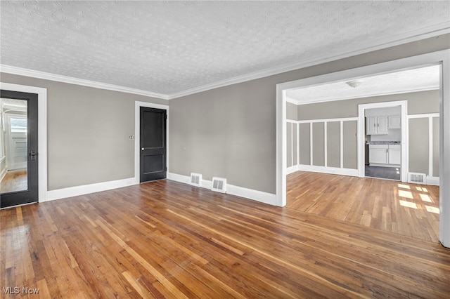 12117 Craven Ave, Cleveland, OH 44105 - unfurnished room with wood-type flooring, a textured ceiling, baseboards, and ornamental molding