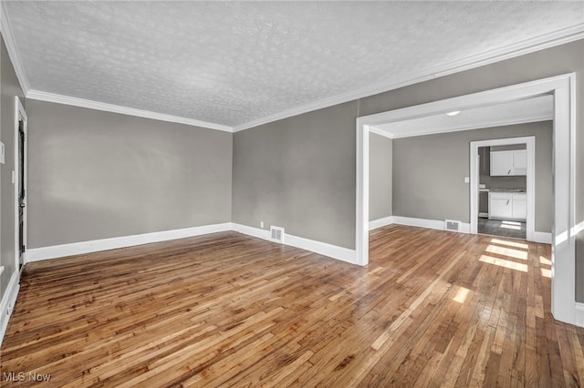 12117 Craven Ave, Cleveland, OH 44105 - empty room featuring wood-type flooring, a textured ceiling, baseboards, and ornamental molding