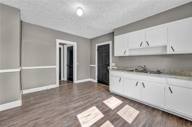 12117 Craven Ave, Cleveland, OH 44105 - kitchen with a sink, open shelves, dark wood-style floors, white cabinetry, and a textured ceiling
