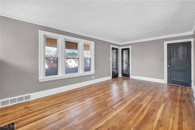 12117 Craven Ave, Cleveland, OH 44105 - empty room featuring a textured ceiling, hardwood / wood-style floors, baseboards, and crown molding