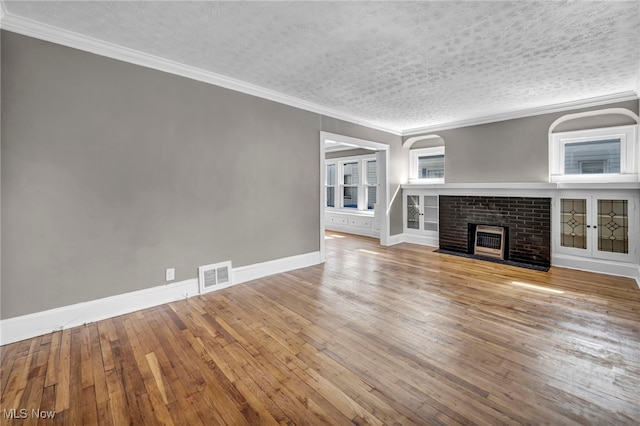 12117 Craven Ave, Cleveland, OH 44105 - unfurnished living room featuring a fireplace, hardwood / wood-style floors, crown molding, baseboards, and arched walkways
