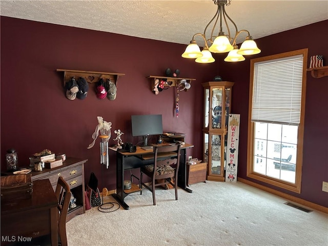 office with a textured ceiling, carpet, visible vents, and a chandelier