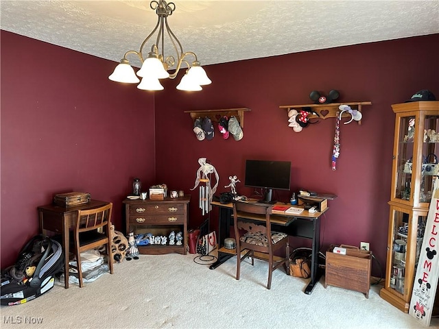 home office with a textured ceiling, a chandelier, and carpet flooring