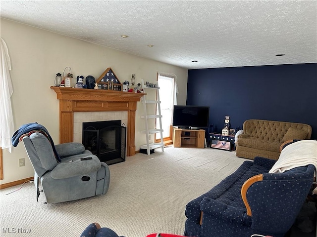 carpeted living area featuring a fireplace, baseboards, and a textured ceiling