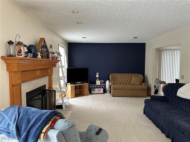 living area with carpet flooring, a textured ceiling, and a fireplace