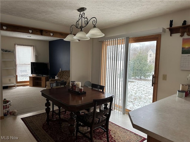 dining space with a textured ceiling