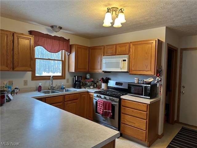 kitchen featuring a sink, light countertops, and stainless steel appliances