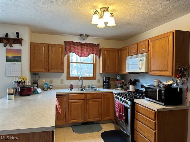 kitchen featuring a sink, white microwave, stainless steel range with gas cooktop, and brown cabinetry