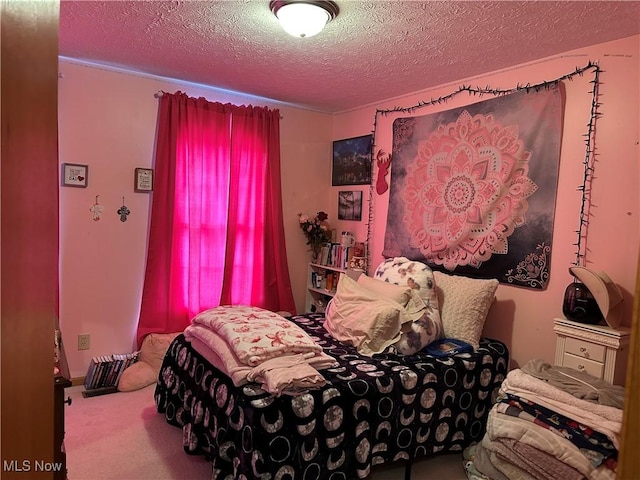 carpeted bedroom featuring a textured ceiling