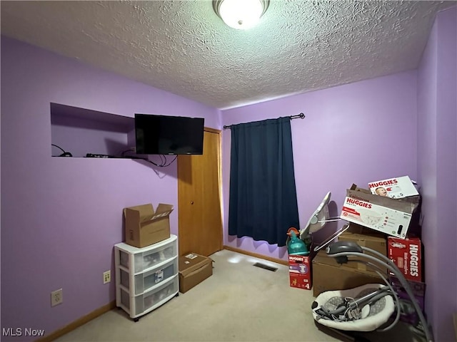 game room featuring carpet, visible vents, and a textured ceiling