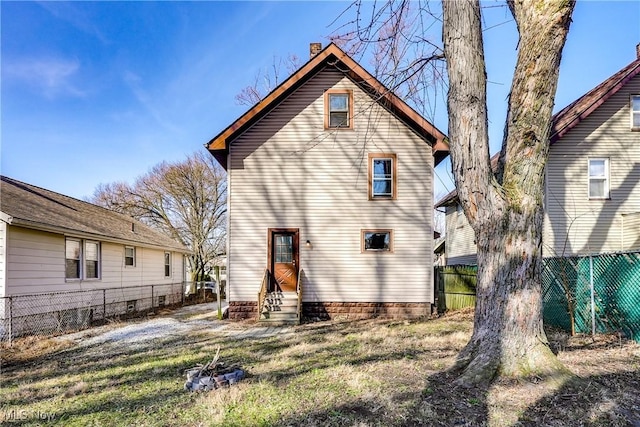 back of property featuring entry steps and fence