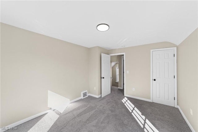 unfurnished bedroom featuring carpet flooring, baseboards, and visible vents