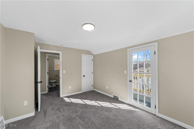 unfurnished bedroom with visible vents, carpet flooring, baseboards, access to exterior, and vaulted ceiling