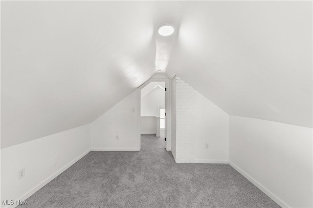 bonus room with lofted ceiling, carpet, and baseboards