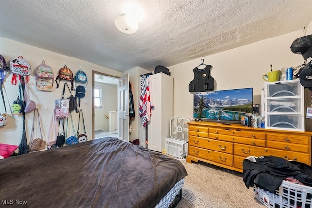 bedroom with carpet flooring and a textured ceiling