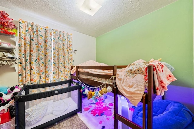 carpeted bedroom with a textured ceiling and vaulted ceiling