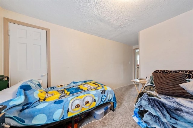 carpeted bedroom featuring a textured ceiling and baseboards