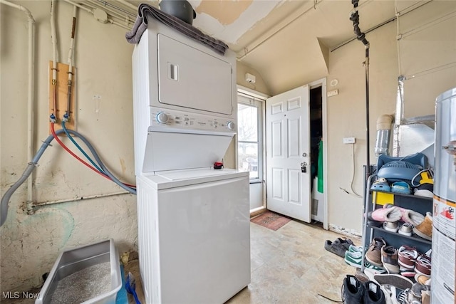 laundry area featuring gas water heater and stacked washer and clothes dryer