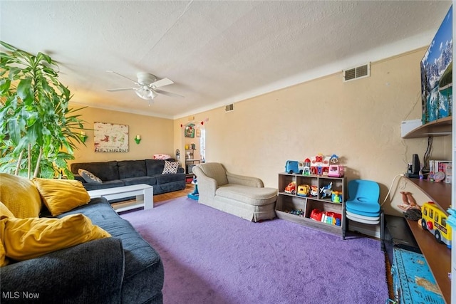 living room featuring visible vents, a textured ceiling, and ceiling fan