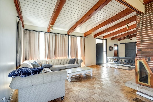 living room with beamed ceiling and baseboards