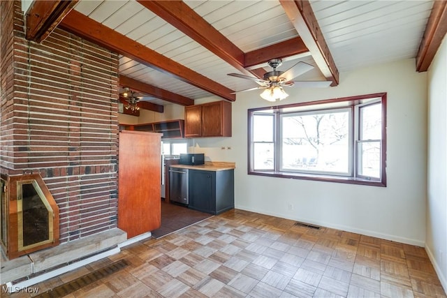 kitchen with visible vents, beamed ceiling, brown cabinets, stainless steel dishwasher, and baseboards