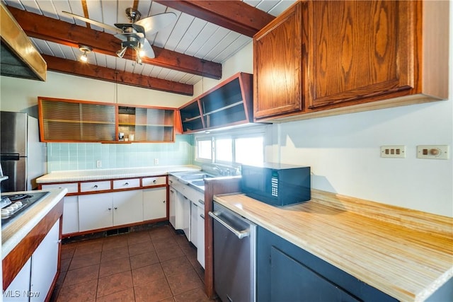 kitchen featuring dark tile patterned floors, light countertops, appliances with stainless steel finishes, a ceiling fan, and open shelves