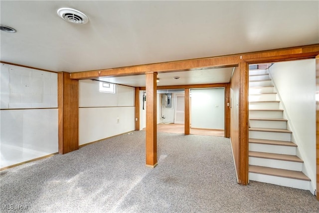 basement with visible vents, carpet floors, and stairs