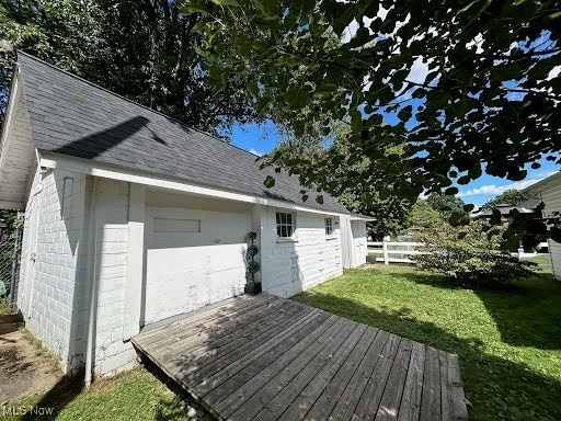 wooden terrace featuring a lawn and fence