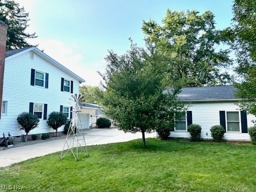 exterior space with a front yard, a garage, and driveway