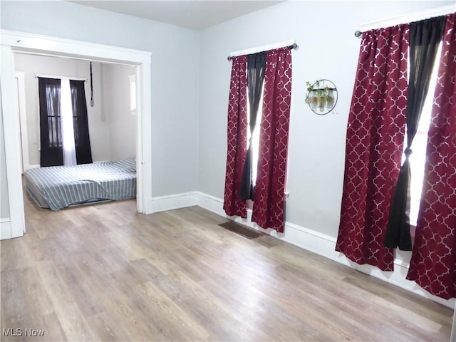 unfurnished bedroom featuring baseboards and wood finished floors