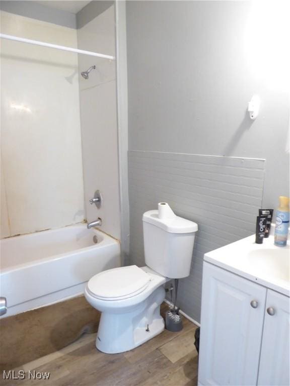 bathroom with vanity, toilet, shower / bathing tub combination, and wood finished floors