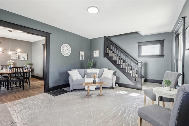 living area featuring stairway, wood finished floors, and baseboards