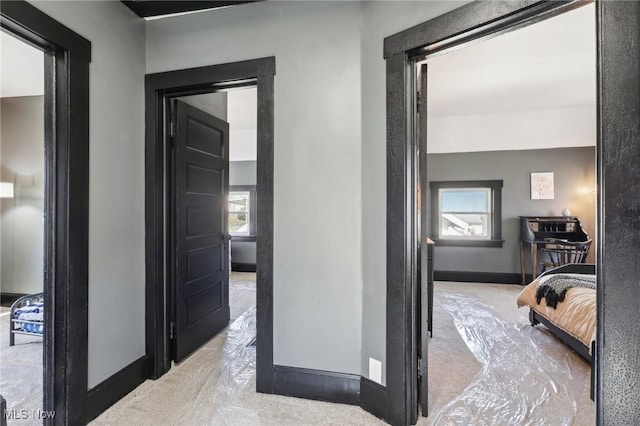 hallway with baseboards and a wealth of natural light