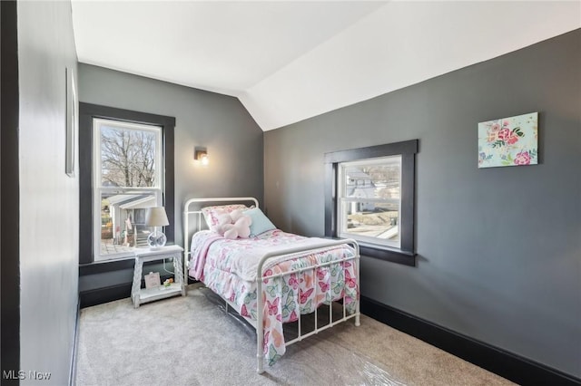 carpeted bedroom with lofted ceiling