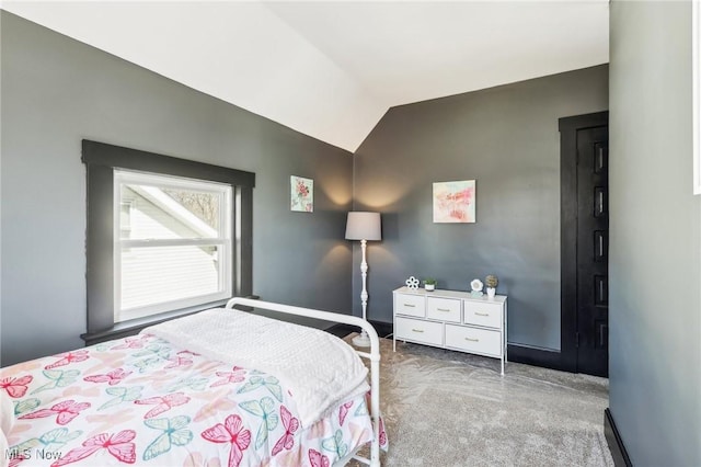 carpeted bedroom featuring vaulted ceiling