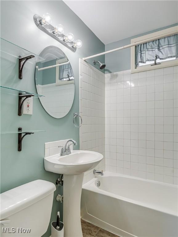 bathroom with toilet and bathtub / shower combination