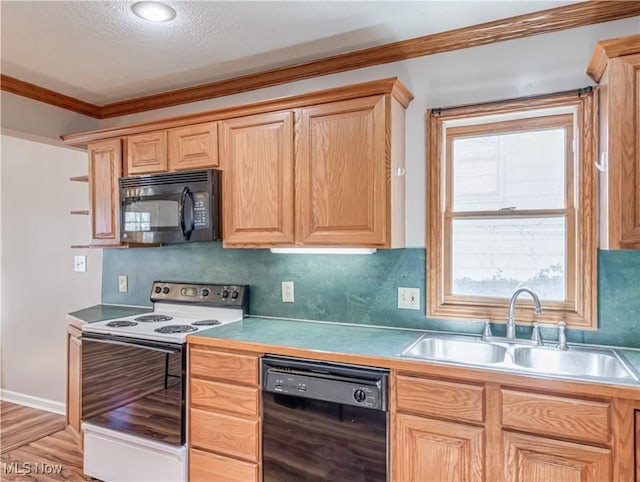 kitchen featuring light brown cabinetry, ornamental molding, decorative backsplash, black appliances, and a sink