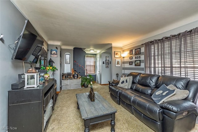 carpeted living room with stairway and baseboards