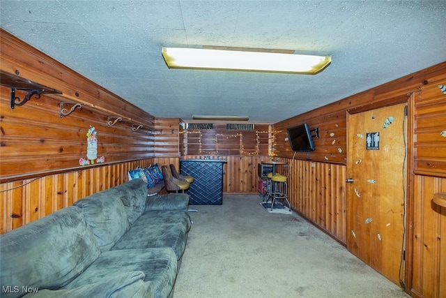 carpeted living room with wooden walls