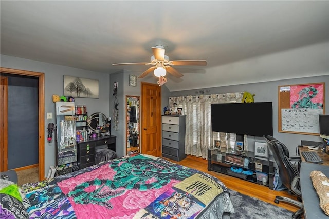 bedroom with a ceiling fan and wood finished floors