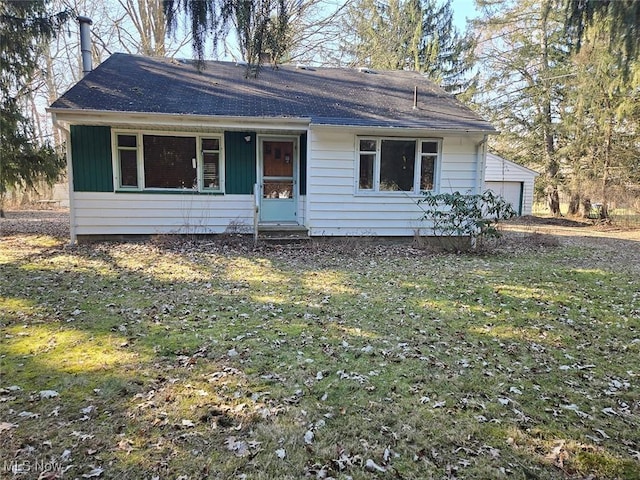 view of front of property with a garage and a front lawn