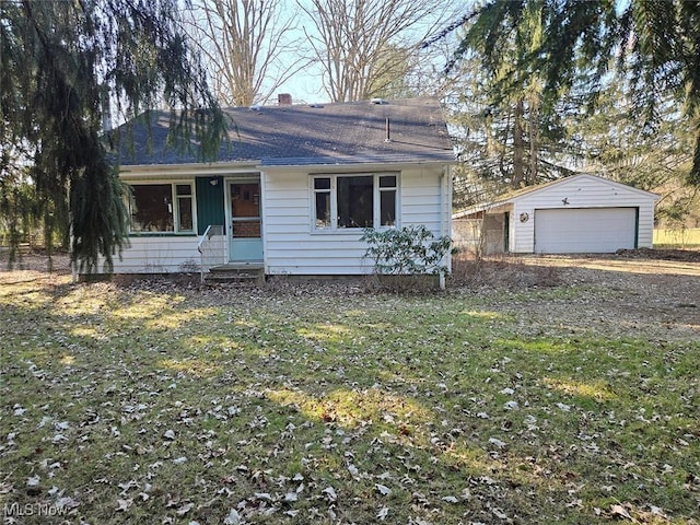 view of front facade with entry steps, an outbuilding, a garage, and a chimney