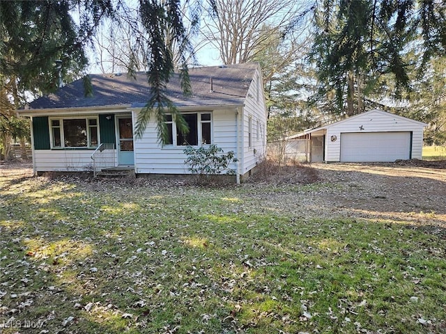 view of front of property featuring a garage and an outdoor structure