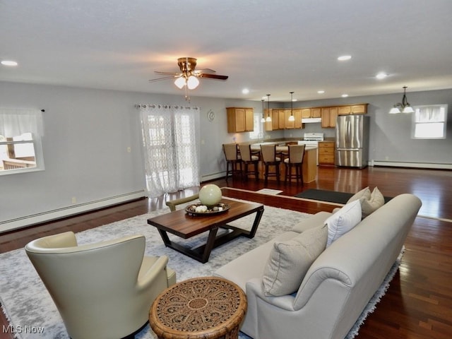 living room with dark wood-style floors, recessed lighting, and baseboard heating