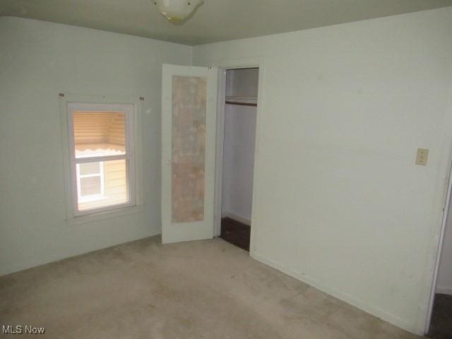 unfurnished bedroom with a closet and carpet floors