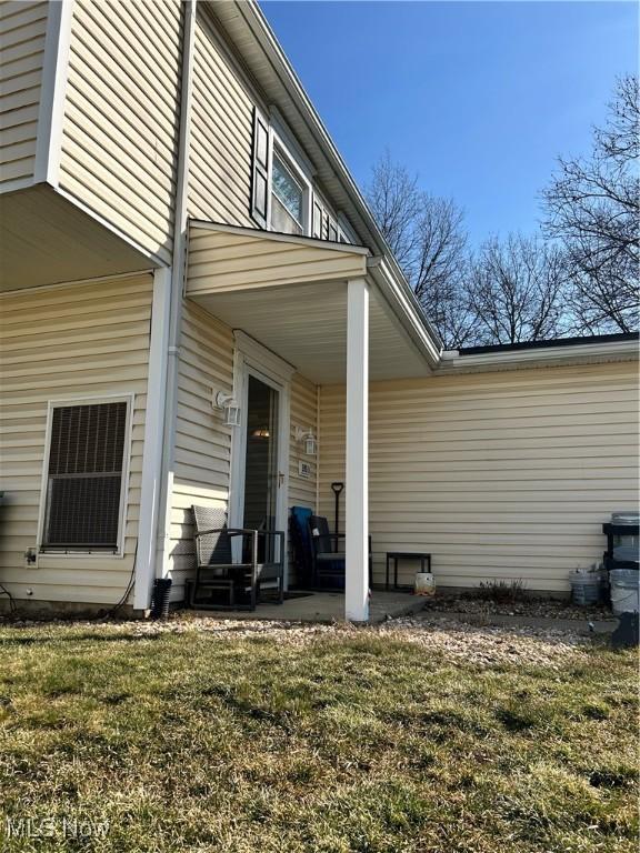 view of side of property with a yard