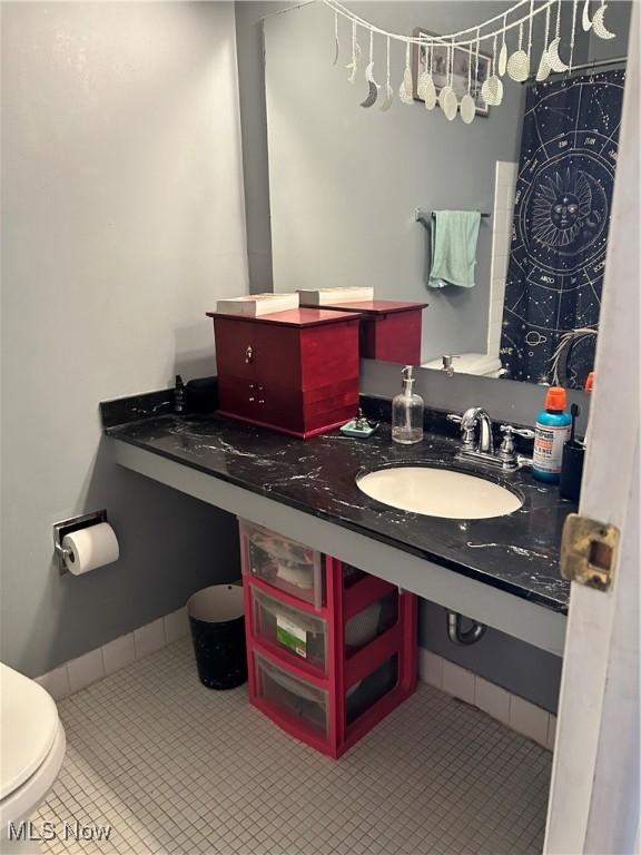 full bath featuring tile patterned floors, toilet, and vanity