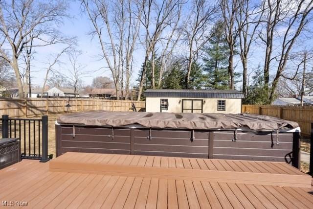 wooden deck with an outbuilding and a fenced backyard