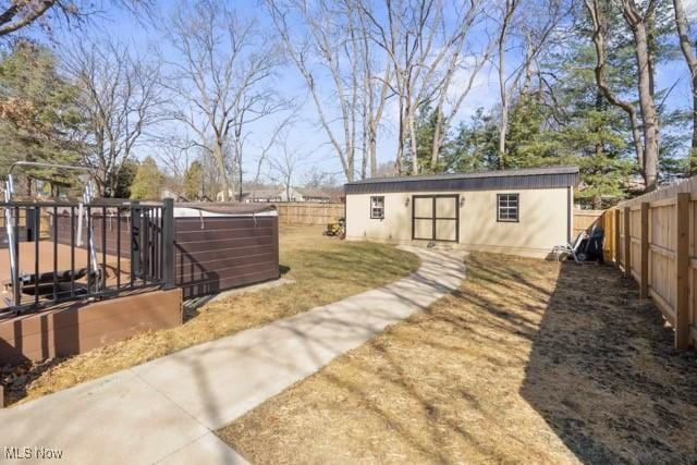 view of yard with an outdoor structure and a fenced backyard